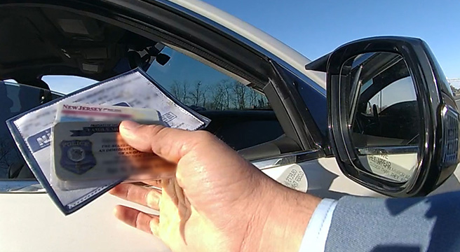 Photo: Police officer holding documents during a traffic stop